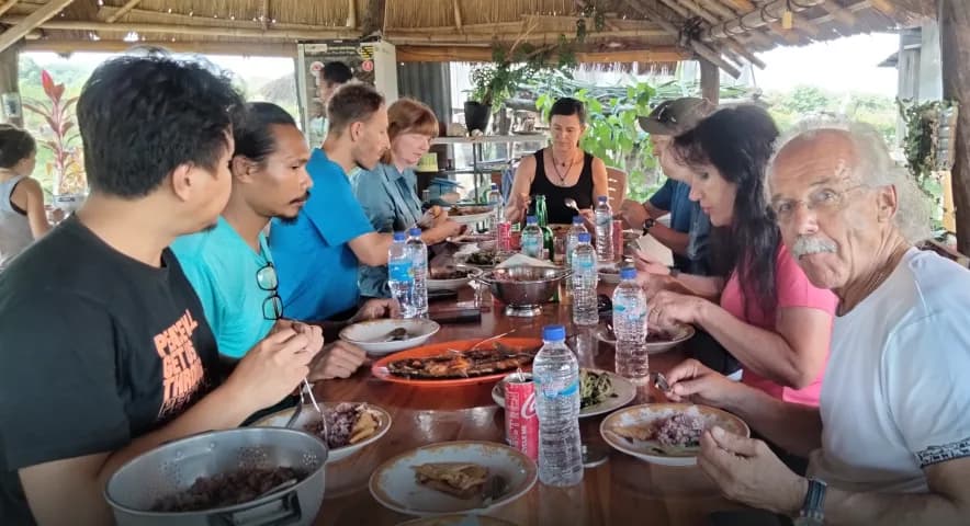 Guests sharing a home-cooked meal at Waerebo Lodge Restaurant