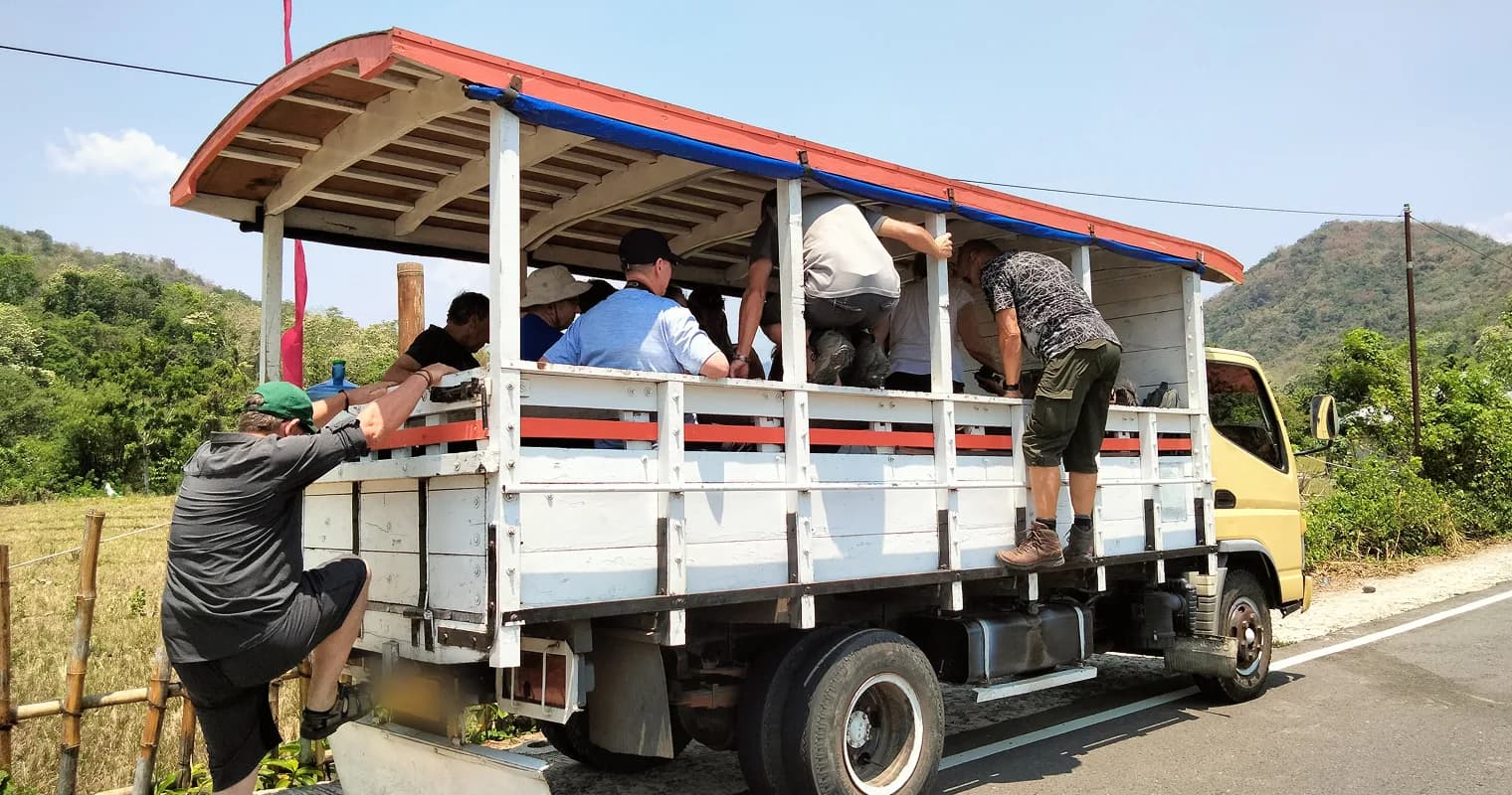 Travelers boarding the Oto Colt transport truck